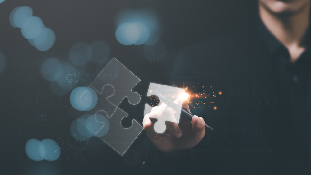 Decorative image featuring man holding a stylus, positioning a virtual jigsaw piece to complete a puzzle